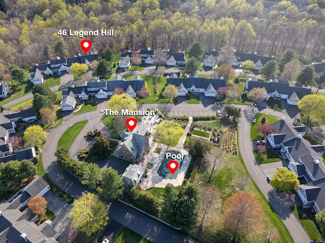 drone / aerial view featuring a residential view and a view of trees