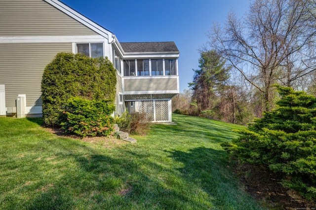 view of property exterior with a lawn, roof with shingles, and a sunroom
