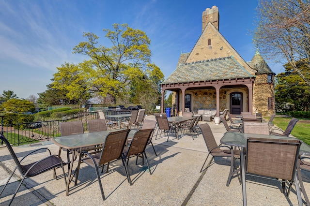 view of patio featuring outdoor lounge area, outdoor dining area, and fence
