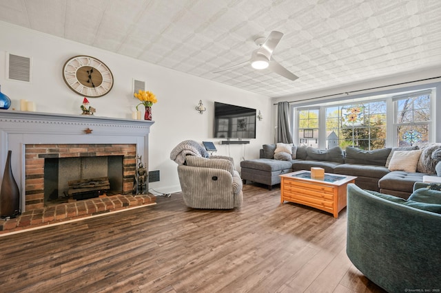 9 Berkshire Dr, Danbury, CT 06811 - living area featuring visible vents, a ceiling fan, wood finished floors, and a fireplace