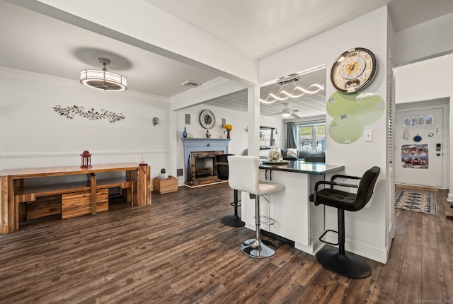 9 Berkshire Dr, Danbury, CT 06811 - kitchen featuring a breakfast bar area, dark wood-style flooring, dark countertops, baseboards, and open floor plan