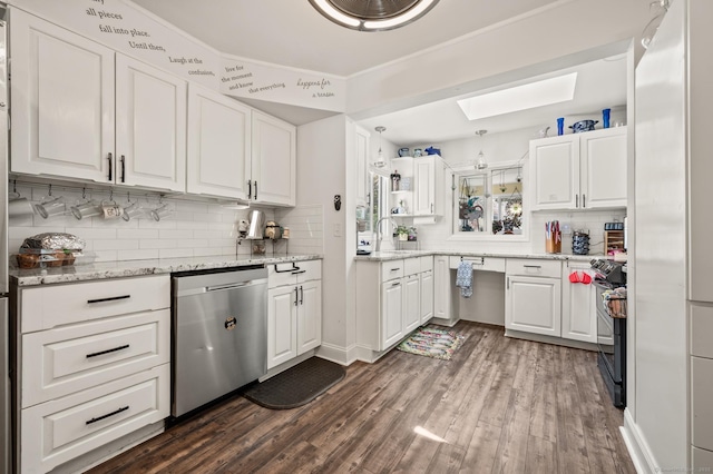9 Berkshire Dr, Danbury, CT 06811 - kitchen with white cabinets, tasteful backsplash, dark wood finished floors, a skylight, and stainless steel appliances
