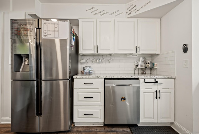 9 Berkshire Dr, Danbury, CT 06811 - kitchen with dark wood-style floors, white cabinets, tasteful backsplash, light stone counters, and stainless steel appliances