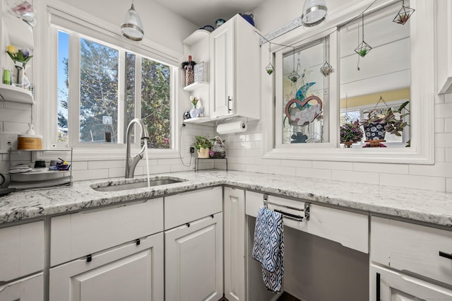9 Berkshire Dr, Danbury, CT 06811 - kitchen with white cabinets, open shelves, a sink, a wealth of natural light, and backsplash