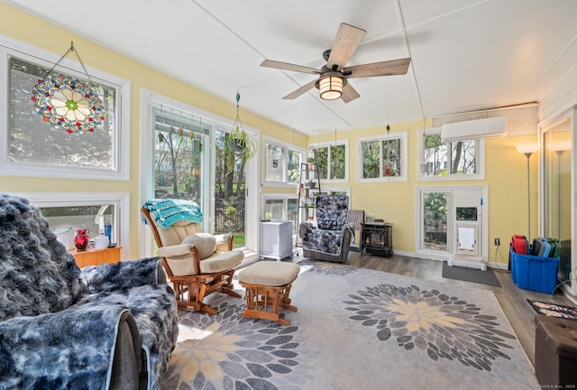9 Berkshire Dr, Danbury, CT 06811 - sunroom with wood finished floors, a wood stove, baseboards, and a wall mounted AC
