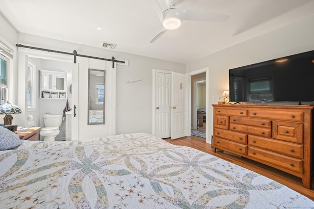 9 Berkshire Dr, Danbury, CT 06811 - bedroom with visible vents, a barn door, wood finished floors, and multiple windows