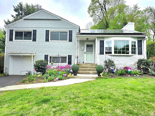 9 Berkshire Dr, Danbury, CT 06811 - tri-level home featuring an attached garage, a chimney, a front lawn, and aphalt driveway