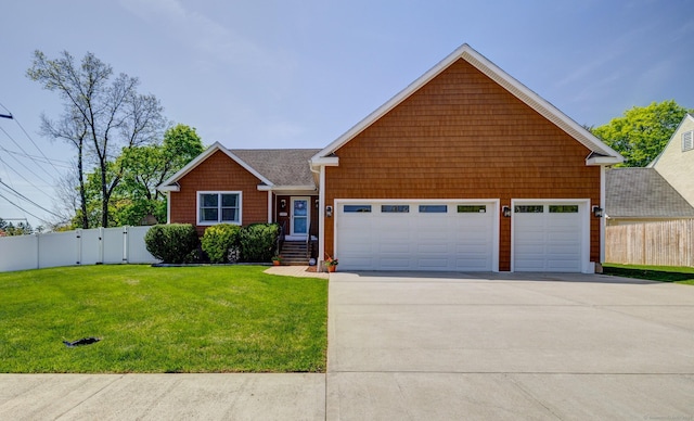 view of front of home with fence, an attached garage, driveway, and a front yard