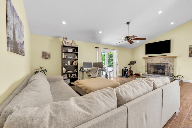 living area featuring ceiling fan, a fireplace, light wood-style floors, recessed lighting, and lofted ceiling