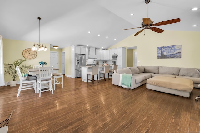 living room with recessed lighting, dark wood finished floors, ceiling fan with notable chandelier, and high vaulted ceiling