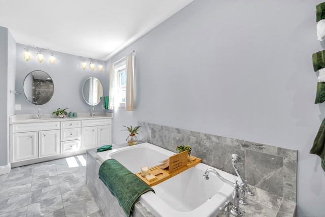 full bathroom featuring double vanity, a sink, a garden tub, and marble finish floor