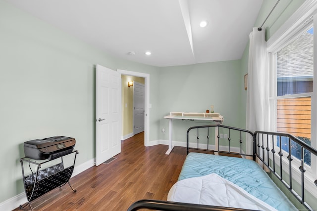 bedroom featuring baseboards, recessed lighting, and wood finished floors
