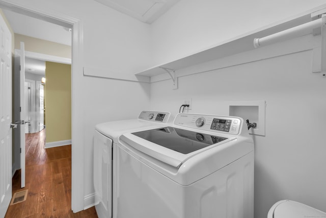 washroom featuring laundry area, dark wood-style flooring, independent washer and dryer, visible vents, and baseboards