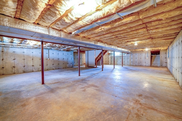 unfinished basement featuring stairway