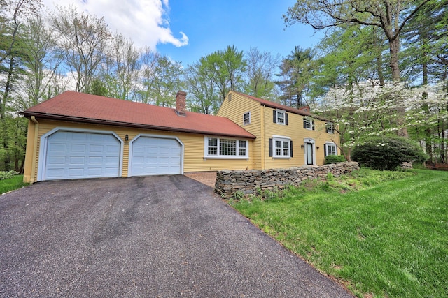 30 Sunset Hill Rd, Simsbury, CT 06070 - view of front facade with asphalt driveway, a chimney, an attached garage, and a front lawn