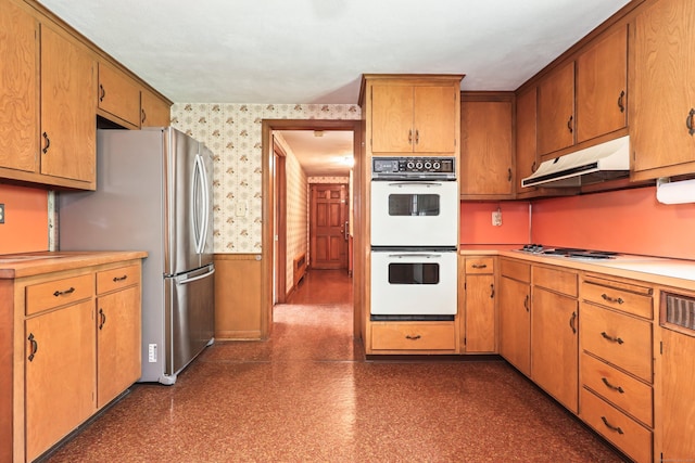 30 Sunset Hill Rd, Simsbury, CT 06070 - kitchen with under cabinet range hood, stainless steel appliances, wallpapered walls, a wainscoted wall, and light countertops