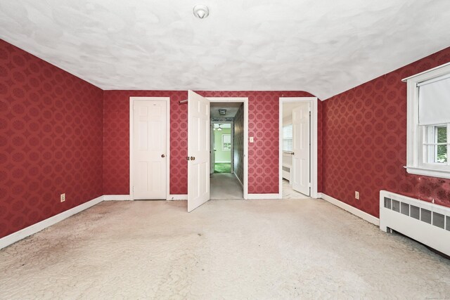 30 Sunset Hill Rd, Simsbury, CT 06070 - unfurnished bedroom with radiator, carpet floors, baseboards, wallpapered walls, and connected bathroom
