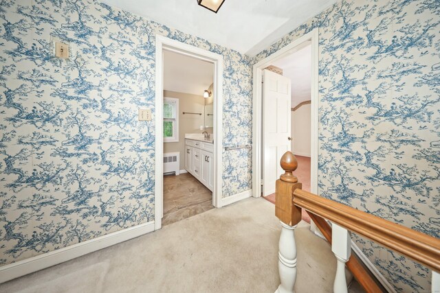 30 Sunset Hill Rd, Simsbury, CT 06070 - hall featuring wallpapered walls, radiator, an upstairs landing, light colored carpet, and baseboards