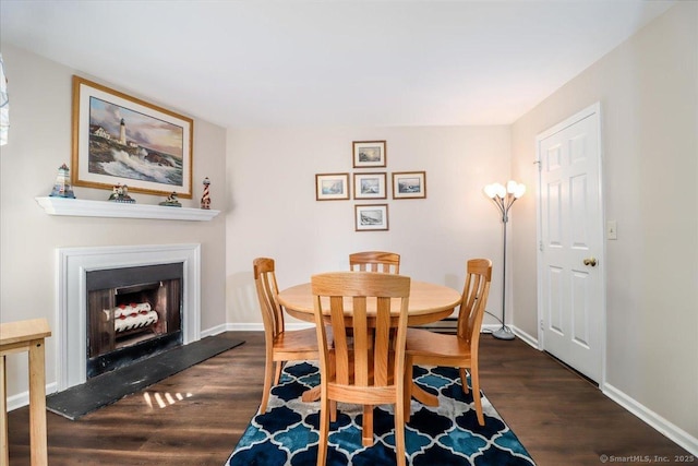 20 E Pembroke Rd Unit 36, Danbury, CT 06811 - dining room featuring baseboards, a fireplace with raised hearth, and wood finished floors