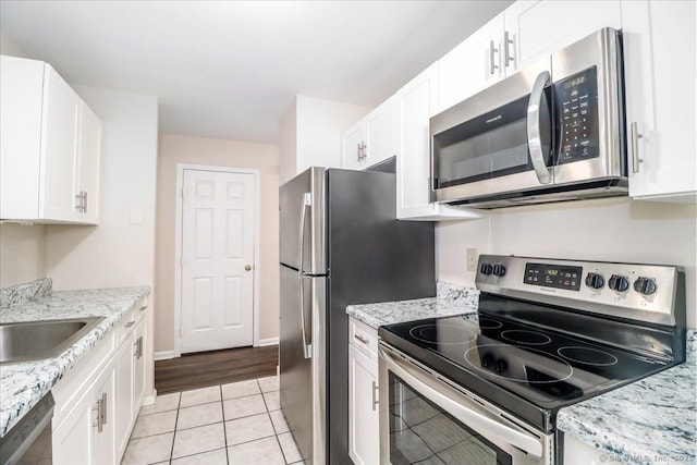 20 E Pembroke Rd Unit 36, Danbury, CT 06811 - kitchen with white cabinetry, light tile patterned floors, and stainless steel appliances
