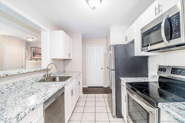 20 E Pembroke Rd Unit 36, Danbury, CT 06811 - kitchen featuring white cabinetry, appliances with stainless steel finishes, a sink, and light stone counters