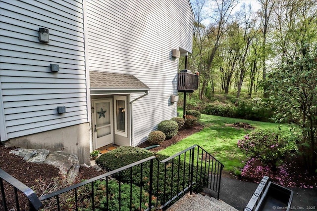 20 E Pembroke Rd Unit 36, Danbury, CT 06811 - view of exterior entry with a yard and a shingled roof