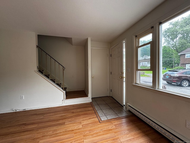 136 Westbury Park Rd Apt C, Watertown, CT 06795 - foyer featuring baseboard heating, stairway, plenty of natural light, and light wood-style flooring