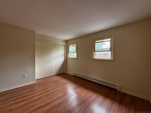 136 Westbury Park Rd Apt C, Watertown, CT 06795 - unfurnished room with a baseboard radiator, wood finished floors, and baseboards