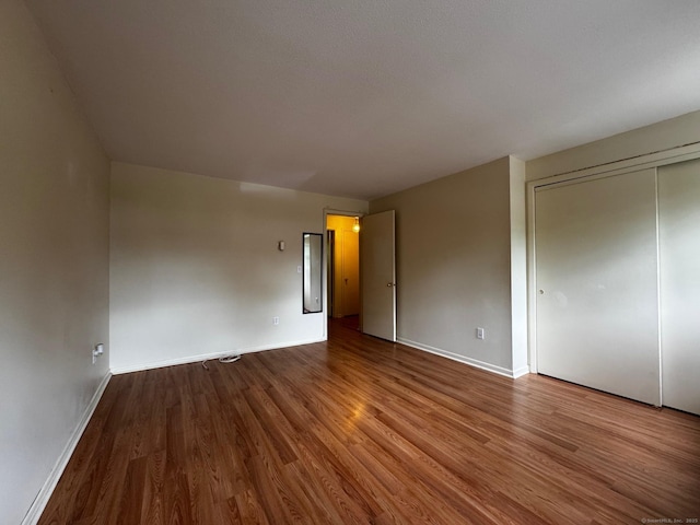 136 Westbury Park Rd Apt C, Watertown, CT 06795 - unfurnished bedroom with wood finished floors, baseboards, and a closet