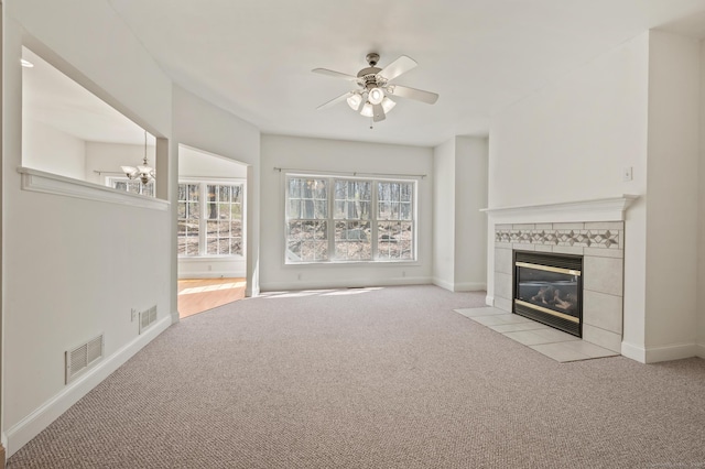 unfurnished living room featuring ceiling fan, visible vents, baseboards, light carpet, and a tiled fireplace
