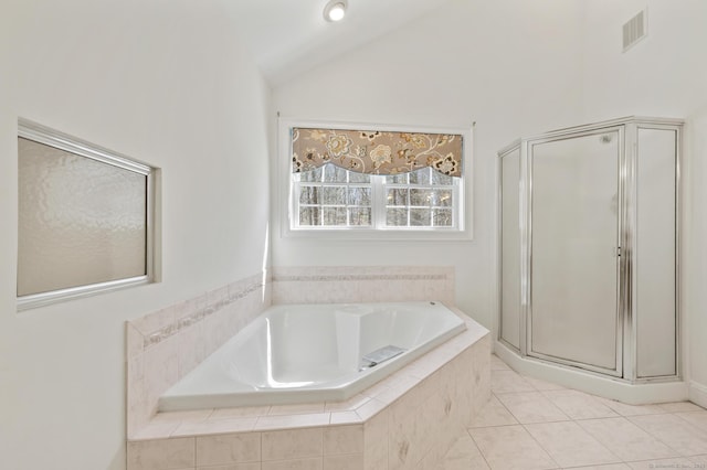 full bath featuring a shower stall, a bath, tile patterned floors, visible vents, and vaulted ceiling