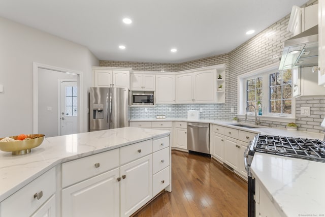 kitchen featuring a sink, white cabinets, appliances with stainless steel finishes, and tasteful backsplash