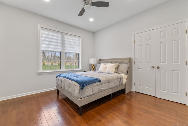 bedroom featuring recessed lighting, wood-type flooring, a closet, ceiling fan, and baseboards