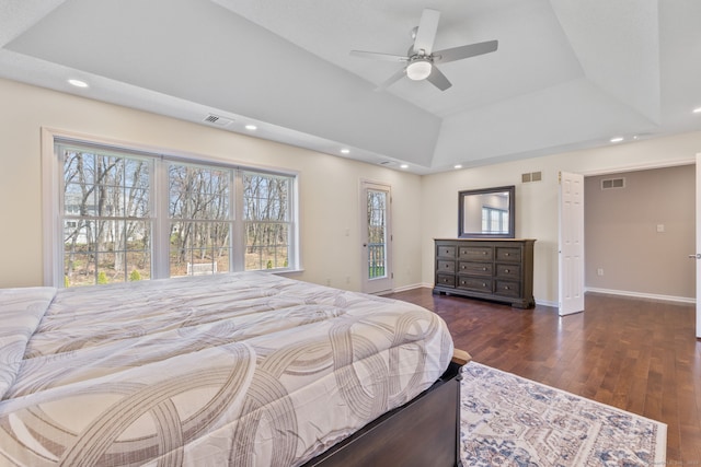 bedroom with visible vents, wood finished floors, and multiple windows