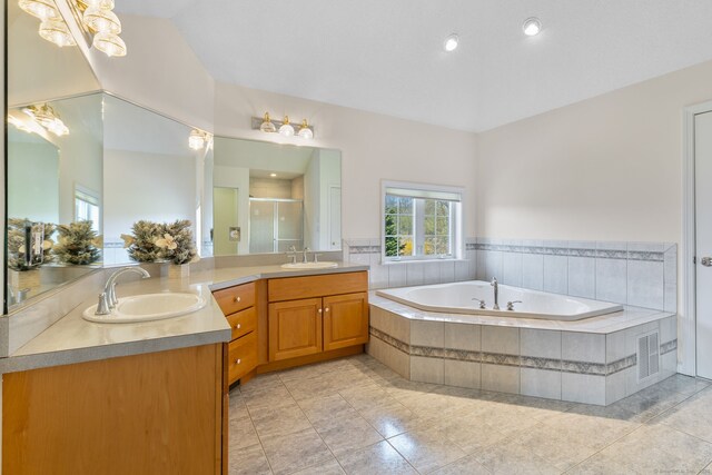 bathroom featuring vanity, a bath, a stall shower, visible vents, and tile patterned flooring