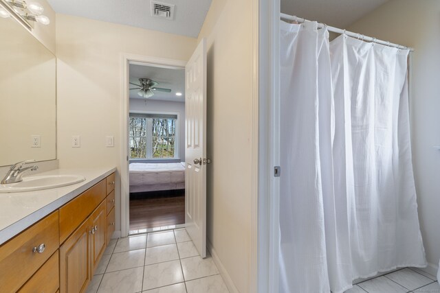 bathroom with connected bathroom, ceiling fan, visible vents, vanity, and tile patterned flooring