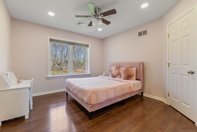 bedroom with dark wood-type flooring, visible vents, recessed lighting, and baseboards