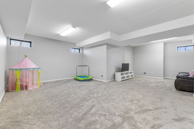 game room with visible vents, a wealth of natural light, carpet, and baseboards
