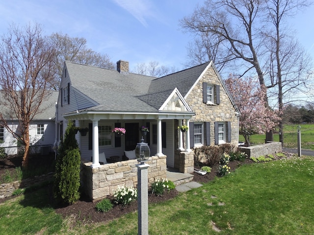 496 Foote Rd, Glastonbury, CT 06073 - view of front of home featuring a chimney, a porch, a shingled roof, stone siding, and a front lawn