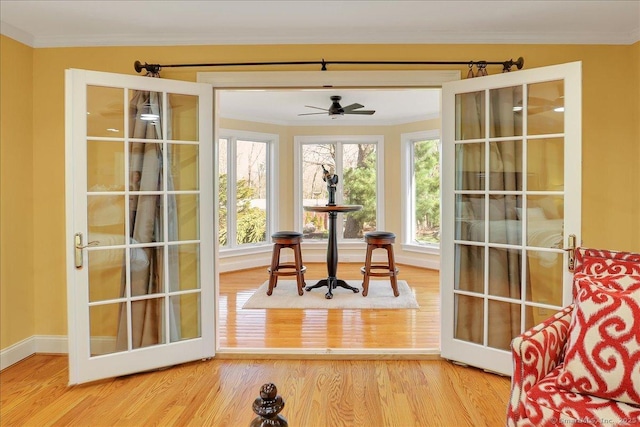 496 Foote Rd, Glastonbury, CT 06073 - doorway to outside with baseboards, wood finished floors, a ceiling fan, and crown molding