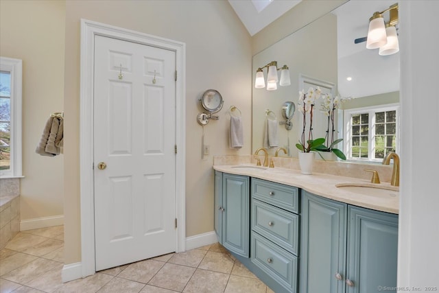 496 Foote Rd, Glastonbury, CT 06073 - full bathroom with double vanity, lofted ceiling with skylight, tile patterned flooring, and a sink