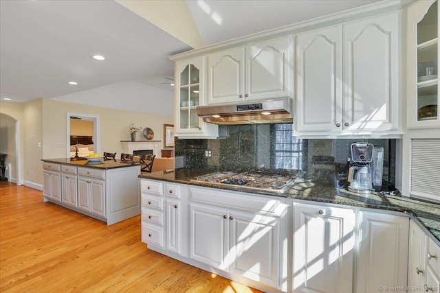 496 Foote Rd, Glastonbury, CT 06073 - kitchen with stainless steel gas stovetop, under cabinet range hood, tasteful backsplash, light wood-type flooring, and lofted ceiling