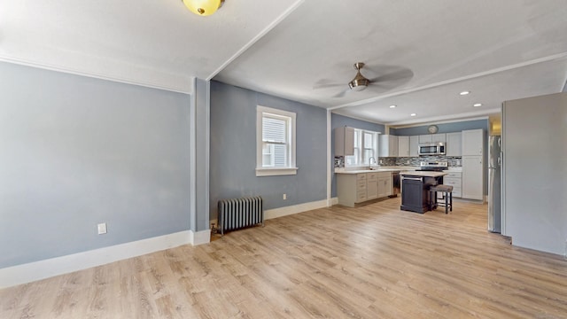 40 Penobscot St, Norwich, CT 06360 - kitchen with light wood-style floors, ceiling fan, radiator heating unit, light countertops, and appliances with stainless steel finishes