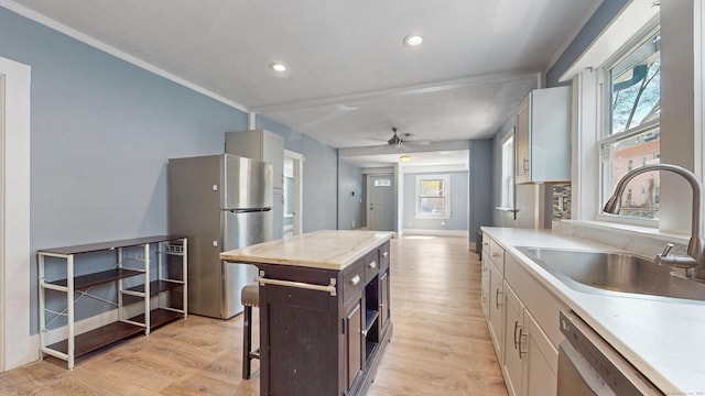 40 Penobscot St, Norwich, CT 06360 - kitchen featuring light countertops, a sink, appliances with stainless steel finishes, and light wood-type flooring