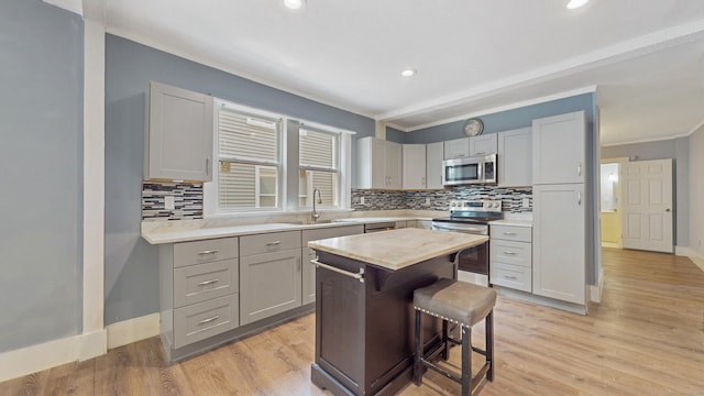 40 Penobscot St, Norwich, CT 06360 - kitchen featuring tasteful backsplash, a sink, appliances with stainless steel finishes, light countertops, and a kitchen bar