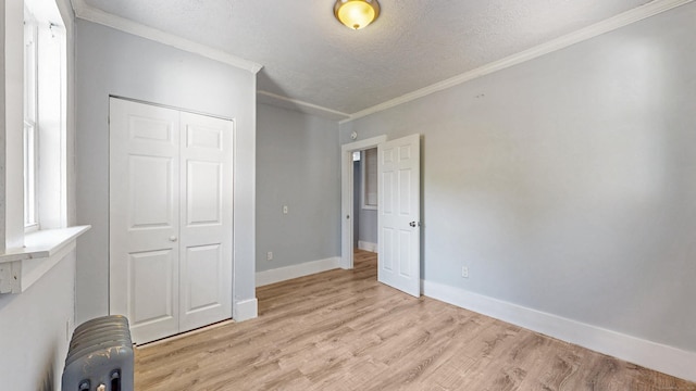 40 Penobscot St, Norwich, CT 06360 - unfurnished bedroom featuring a textured ceiling, light wood-style flooring, a closet, baseboards, and ornamental molding