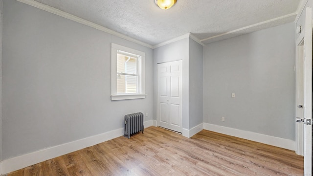 40 Penobscot St, Norwich, CT 06360 - unfurnished bedroom with radiator, a textured ceiling, ornamental molding, and light wood-type flooring