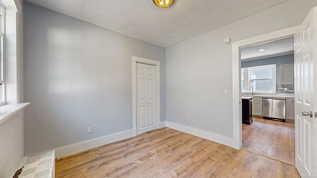 40 Penobscot St, Norwich, CT 06360 - empty room with a textured ceiling, baseboards, and light wood-style floors