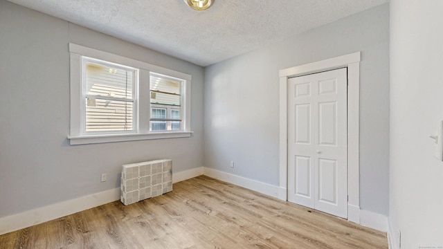 40 Penobscot St, Norwich, CT 06360 - unfurnished bedroom with a textured ceiling, a closet, light wood-style flooring, and baseboards