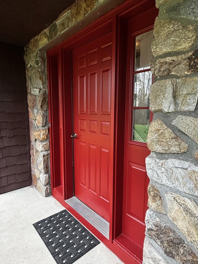 entrance to property featuring stone siding